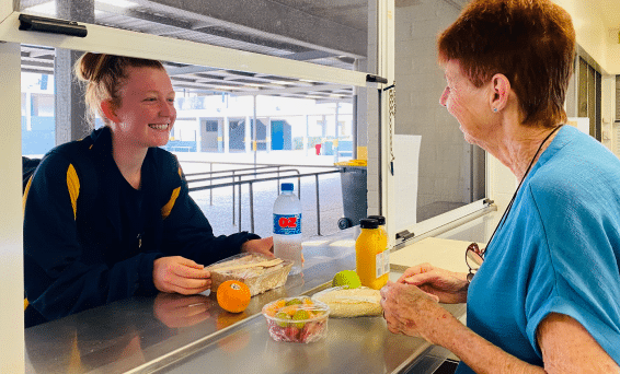 Brisbane Water Secondary College canteen supervisor Michele Parker and student Charli Grant.