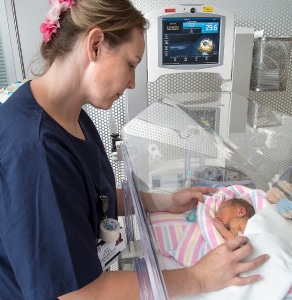 A midwife tends to a newborn baby.
