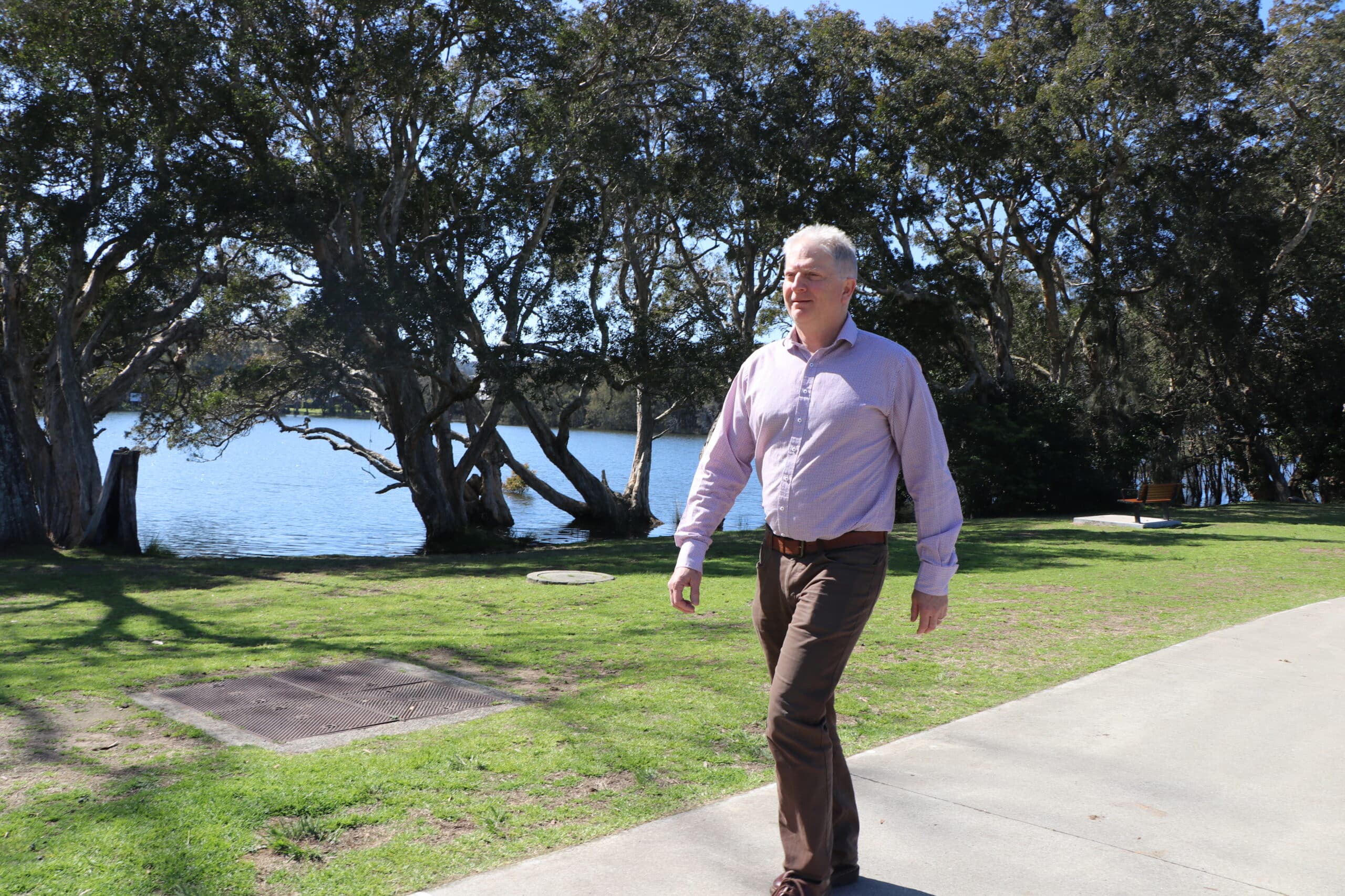 Brett Andrew walking along a pathway.