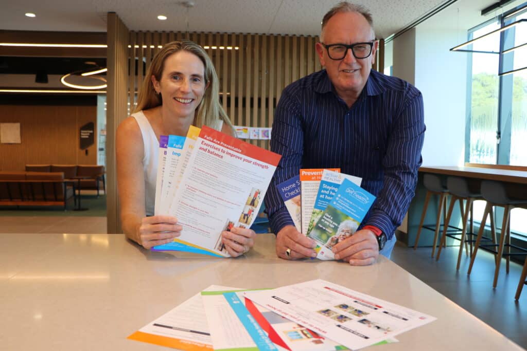 Niki Kajons, director of health promotion and population health improvement at Central Coast Local Health District, and Dennis Taylor, chief executive officer of Meals on Wheels Central Coast, with some of the resources that will go out to Meals on Wheels customers.
