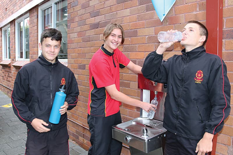 Students from St Edward's College filling up water from the school's chilled water station.