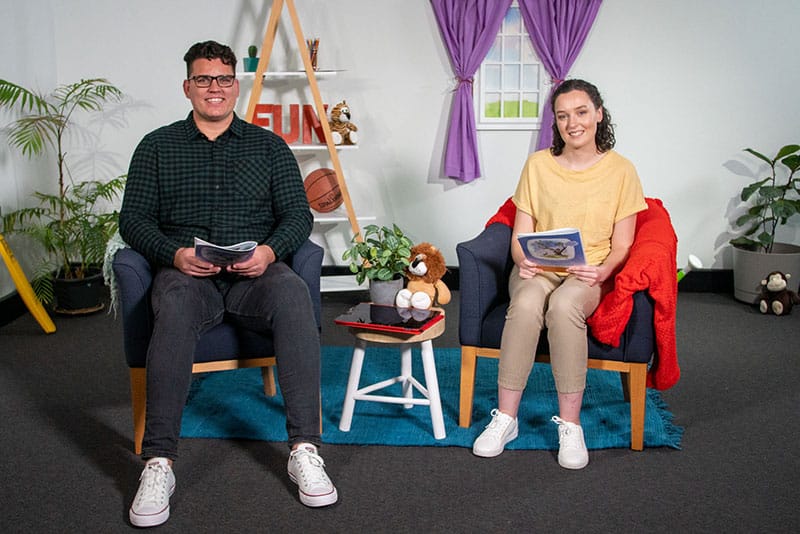 A young man and woman on set preparing to read Jack's FUNtastic Day.