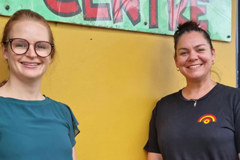 A member of the health promotion team (Nina Douglass) smiling next to Amanda, a staff member from San Remo Neighbourhood Centre.