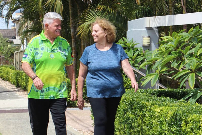 Two Aboriginal older adults walking along the street