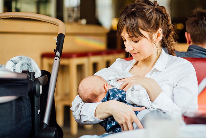 A woman breastfeeding in public.