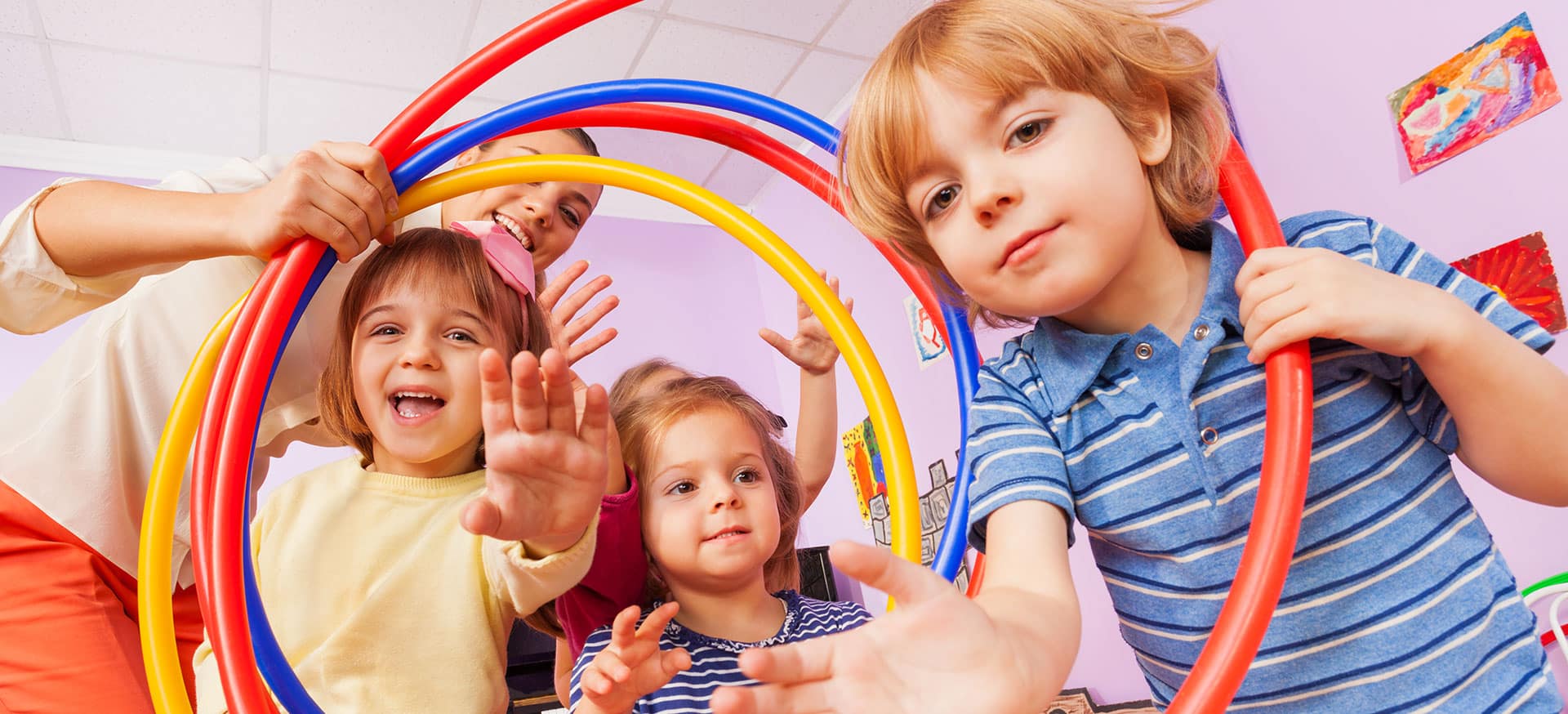 Young children in an early childhood service with hoola hoops.