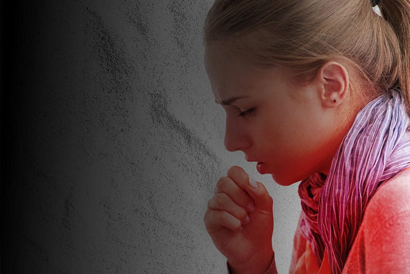 A young girl coughing.