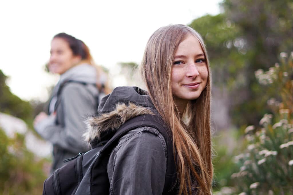 Cover image with two young women hiking - Health Promotion Action_Year in Review 2024-2