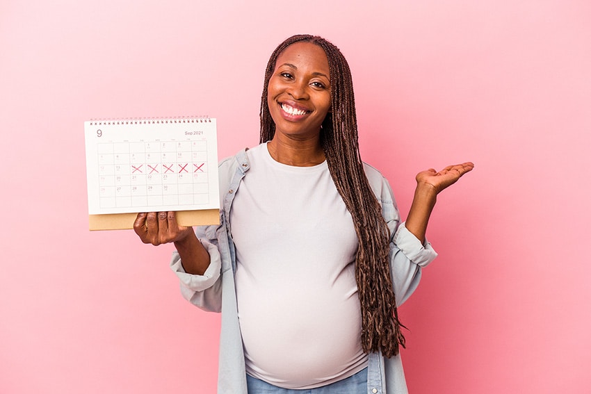 Pregnant lady holding a calendar