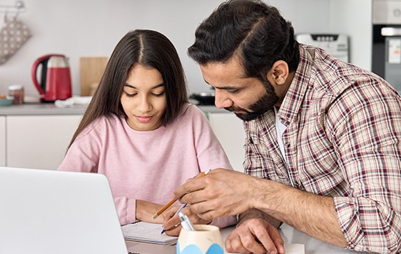 dad and daughter doing homework together