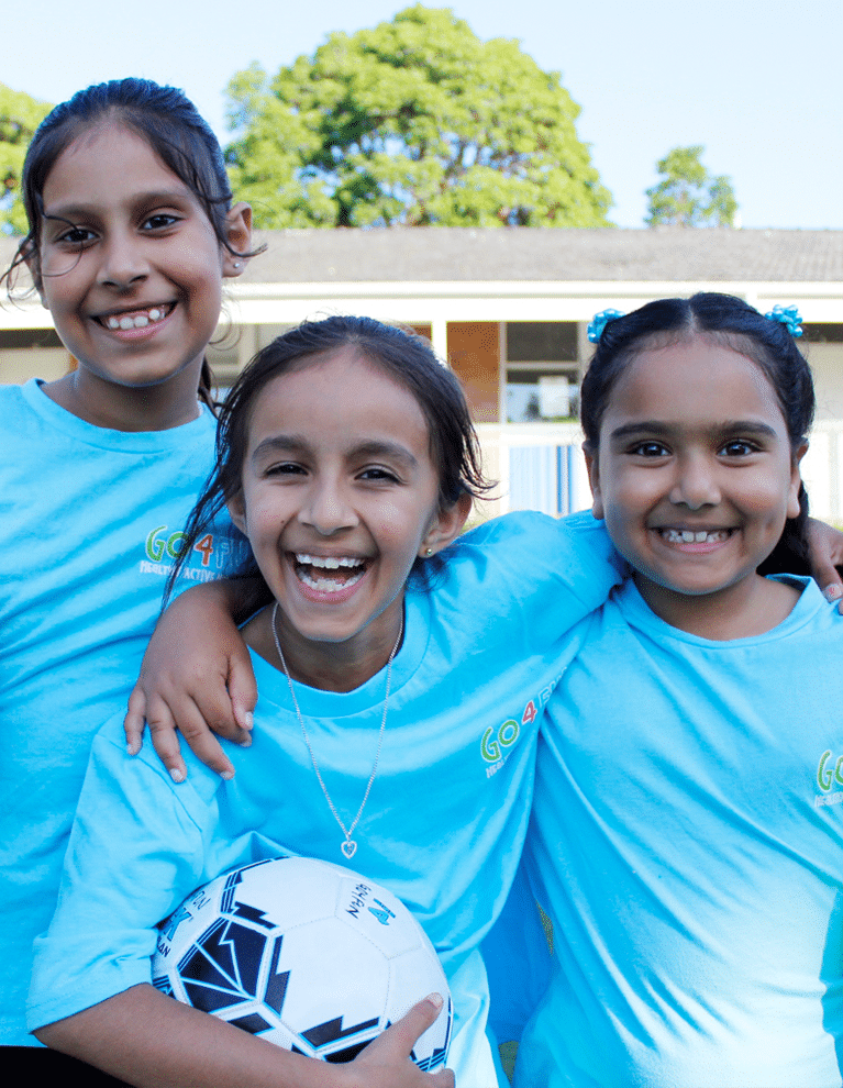 three girls with soccer ball attending Go4Fun